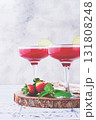 Refreshing cocktail in an elegant glass with lime and strawberries, sunshine, no people, 131808248