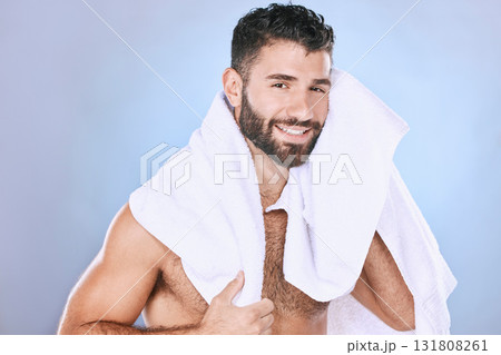 Man after shower with hygiene, towel and beauty in portrait, smile, face and grooming in studio. Skincare, cosmetics and cleaning body with healthy skin, mockup and cosmetic care on blue background Man after shower with hygiene, towel and beauty in portrait, smile, face and grooming in studio. Skincare, cosmetics and cleaning body with healthy skin, mockup and cosmetic care on blue background 131808261
