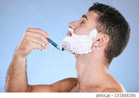 Shaving chin, foam and man with razor, beard maintenance and product placement in studio mock up. Shave cream, face and hair or skincare for male model facial grooming, isolated on blue background. 131808280