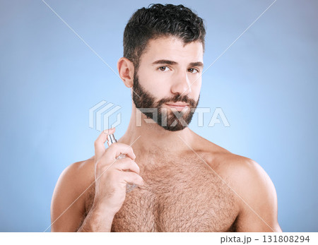 Man portrait, fragrance and skincare bottle product of aftershave, face wellness and luxury cosmetics in studio. Male model, beauty and spraying perfume, parfum and body cologne on blue background Man portrait, fragrance and skincare bottle product of aftershave, face wellness and luxury cosmetics in studio. Male model, beauty and spraying perfume, parfum and body cologne on blue background 131808294