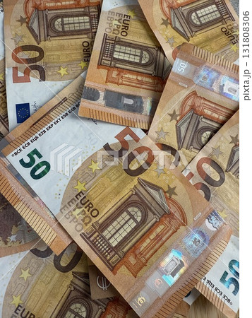 Macro photography of euro currency, highlighting financial themes such as pensions, taxes, income, and losses. Money, economics, and financial literacy. 131808306