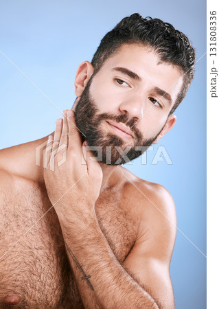 Idea, skin and grooming with a man model in studio on a blue background for natural wellness or beauty. Face, beard and skincare with a handsome young male thinking about cosmetics or treatment 131808336