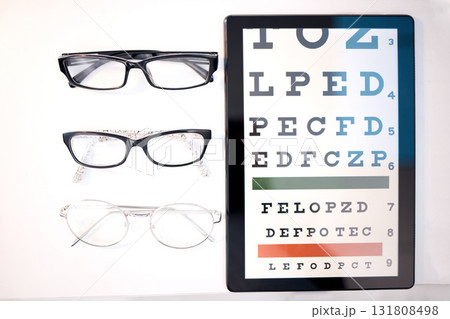Optometry, glasses and letter for eye exam on tablet for sight, vision testing and medical care. Optometrist, healthcare and frames, prescription lens and eyeglasses for eyes with test on screen 131808498