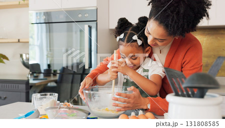 Baking, kitchen and mother with girl learning, helping and bonding for recipe, food and dessert. Happy family, African and mom teaching girl to bake with flour, mix ingredients and cake in home Baking, kitchen and mother with girl learning, helping and bonding for recipe, food and dessert. Happy family, African and mom teaching girl to bake with flour, mix ingredients and cake in home 131808585