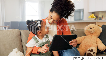 Tablet, sofa and happy mother with child for bonding, healthy relationship and online learning. African family, love and mom with girl on digital tech for streaming video, cartoons and movies in home 131808611