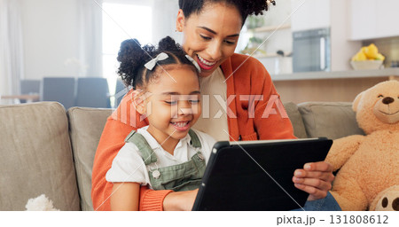 Tablet, sofa and mother with girl in home for bonding, healthy relationship and online learning. African family, happy and mom with child on digital tech for streaming video, cartoons and movies 131808612