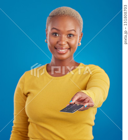Credit card, payment and woman portrait in a studio with a smile from paying with happiness. Isolated, blue background and ecommerce with a young female model hand showing financial banking method 131808703