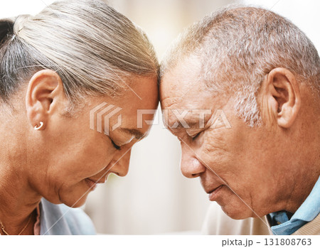 Face, love and trust with a senior couple in their home, touching heads in support or solidarity together. Relax, peace or romance with a mature man and woman bonding in their house during retirement 131808763