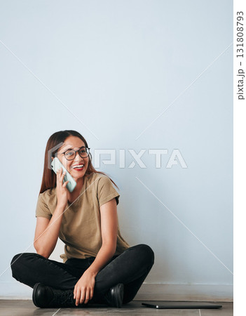 Phone call, floor and happy woman talking in home by wall background with mockup. Cellphone, thinking and person smile while sitting on ground, discussion or conversation, chatting or speaking online Phone call, floor and happy woman talking in home by wall background with mockup. Cellphone, thinking and person smile while sitting on ground, discussion or conversation, chatting or speaking online 131808793