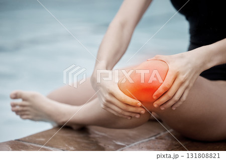 Knee injury, sports and woman at swimming pool with medical pain, body strain and muscle emergency. Legs, red wound and water accident from training, arthritis and athlete anatomy for first aid help Knee injury, sports and woman at swimming pool with medical pain, body strain and muscle emergency. Legs, red wound and water accident from training, arthritis and athlete anatomy for first aid help 131808821