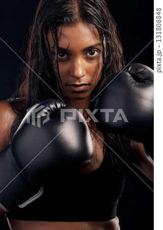 Boxing, gloves and portrait of woman on black background for sports, strong focus or mma training. Female boxer, workout or fist fight of impact, energy and warrior power for studio fitness challenge 131808848