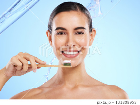 Portrait, water or happy woman brushing teeth smiling with product for healthy oral or dental hygiene in studio. Face, smile beauty or girl model cleaning mouth with natural bamboo wooden toothbrush 131808955