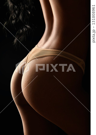 Close-up of an female back on a black background Close-up of an female back on a black background 131808961