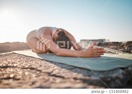 Exercise, yoga and woman stretching on rock for healthy lifestyle, body wellness and cardio workout. Sports, pilates training and girl do meditation, stretch and fitness for zen mindfulness outdoors 131808982