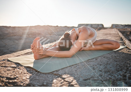 Yoga, wellness and woman stretching body on rock for healthy lifestyle, pilates training and cardio workout. Sports, fitness and girl doing meditation, stretch and exercise for zen, peace and calm 131808999