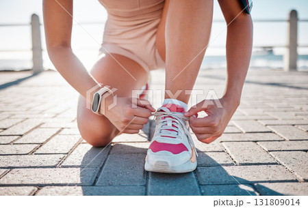 Closeup, fitness and woman tie shoes, training and exercise for wellness, health and performance. Zoom, female athlete and lady with tying shoes, ready for marathon and run for cardio and energy 131809014