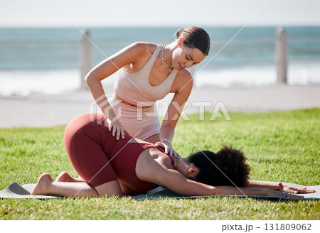 Help, training and women doing yoga at a park for fitness, exercise and stretching support in Spain. Health, warm up and personal trainer with a girl for flexibility during pilates workout in nature 131809062