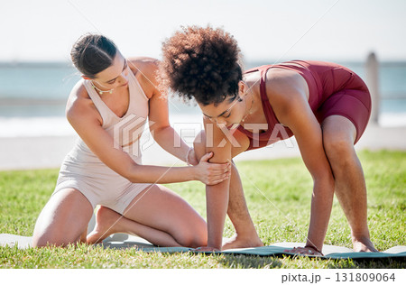 Yoga, personal trainer or women support, helping and learning balance, training and exercise on beach or park. Mentor with black woman or client in pilates workout on grass sports for body wellness 131809064