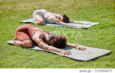 Fitness, woman and yoga on grass field for spiritual wellness, healthy exercise or stretching on mat in nature. Women, friends and yogi in warm up stretch class for zen workout, relax or pilates Fitness, woman and yoga on grass field for spiritual wellness, healthy exercise or stretching on mat in nature. Women, friends and yogi in warm up stretch class for zen workout, relax or pilates 131809073