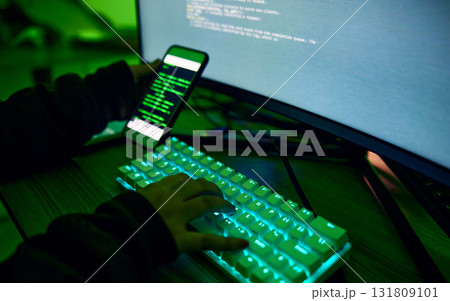 Phone, neon and hands typing on a keyboard while doing website design or coding on a computer at night. Technology, cellphone and male coder working late on webdesign project in office in the evening Phone, neon and hands typing on a keyboard while doing website design or coding on a computer at night. Technology, cellphone and male coder working late on webdesign project in office in the evening 131809101