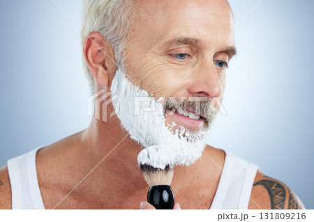 Senior man, beard and shaving cream for skincare, grooming or hair removal against studio background. Mature male face applying shave creme or foam product with brush for haircare or facial treatment 131809216