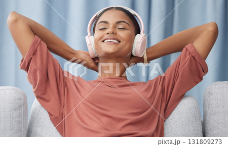 Relax, headphones and woman on a living room sofa feeling peace from music. Web radio, home and podcast of a young female with a smile from zen and stress relief audio on a lounge couch in a house Relax, headphones and woman on a living room sofa feeling peace from music. Web radio, home and podcast of a young female with a smile from zen and stress relief audio on a lounge couch in a house 131809273