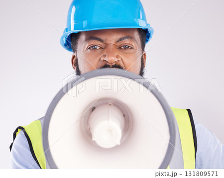 Engineering black man, megaphone and construction in studio portrait for angry shouting by white background. Engineer, architect or manager with loudspeaker in workplace with anger on frustrated face 131809571
