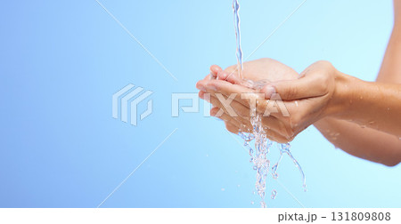 Water splash, woman or cleaning hands in studio on blue background for wellness or skincare hydration. Mockup space banner, palm or girl with liquid splash hand wash in hygiene or bacteria prevention 131809808