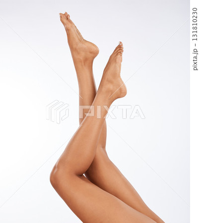 Legs, feet and black woman with epilation and skincare, laser hair removal with waxing on studio background. Cosmetics, beauty and glow with healthy skin, pedicure and spa treatment with mockup space Legs, feet and black woman with epilation and skincare, laser hair removal with waxing on studio background. Cosmetics, beauty and glow with healthy skin, pedicure and spa treatment with mockup space 131810230