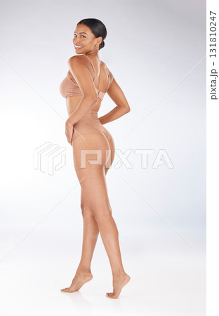 Health, fitness and portrait of a woman in underwear isolated on a grey studio background. Beauty, confidence and happy model in lingerie for promotion, empowerment and body positivity on a backdrop 131810247
