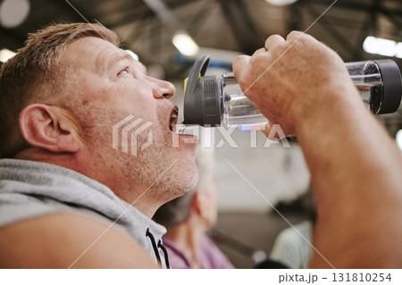 Exercise, man and drinking water in gym, wellness and after training for goal, workout and fitness. Male, athlete and bottle for aqua, liquid and energy for practice, cardio and power with hydration Exercise, man and drinking water in gym, wellness and after training for goal, workout and fitness. Male, athlete and bottle for aqua, liquid and energy for practice, cardio and power with hydration 131810254
