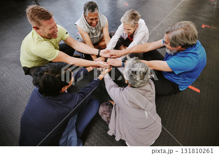 Top view, exercise and senior group holding hands, training goal and celebration for teamwork. Old men and elderly women huddle on floor, touching and connect for achievement, stretch arms or fitness 131810261