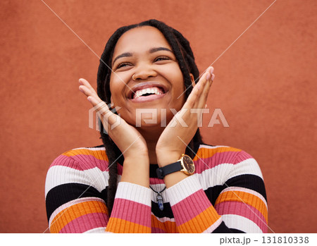 Happy, laugh and freedom with a black woman on an orange background outdoor for joy or humor. Funny, laughter and smile with an african american person laughing or joking against a color wall Happy, laugh and freedom with a black woman on an orange background outdoor for joy or humor. Funny, laughter and smile with an african american person laughing or joking against a color wall 131810338