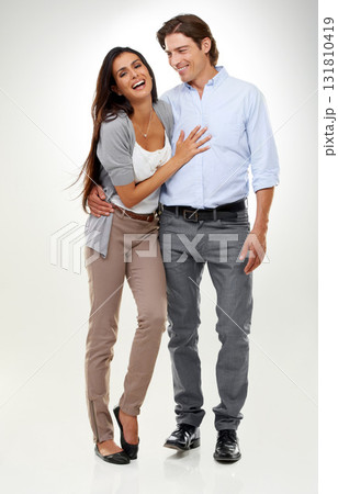 Couple, woman laughing and man portrait in a studio isolated with a happy smile and hug. Calm, happiness and love of a caring male and female model with white background and romance together Couple, woman laughing and man portrait in a studio isolated with a happy smile and hug. Calm, happiness and love of a caring male and female model with white background and romance together 131810419