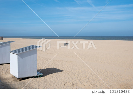 White holiday beach cabins on the beach sand. Wood houses. Ostend, Belgium. White holiday beach cabins on the beach sand. Wood houses. Ostend, Belgium. 131810488