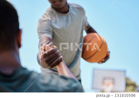 Basketball, help and team on a court playing a match, training or practicing together for a competition. Fitness, sports and man helping his friend on a basketball court during a game or practice. 131810506