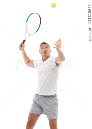 Tennis player, athlete and hitting a ball training, fitness and workout isolated against a studio white background. Man, sports and exercise as a hobby for health and person serve for a match 131810649