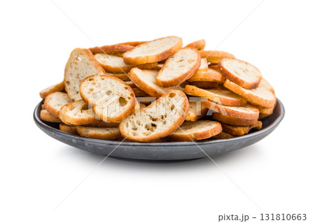 Crispy roasted bruschetta bread on plate  isolated on white background. 131810663