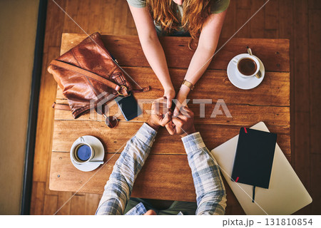 Above, couple and cafe at table with holding hands, love or conversation for romance together. Man, woman and valentines date in coffee shop for support, bonding or talk for happiness, care and trust Above, couple and cafe at table with holding hands, love or conversation for romance together. Man, woman and valentines date in coffee shop for support, bonding or talk for happiness, care and trust 131810854