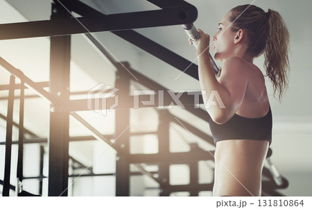 Pull ups, fitness and woman with health, wellness and exercise in a gym for strong arms. Sport, lens flare and training of an athlete with focus and commitment for cardio and body wellbeing Pull ups, fitness and woman with health, wellness and exercise in a gym for strong arms. Sport, lens flare and training of an athlete with focus and commitment for cardio and body wellbeing 131810864