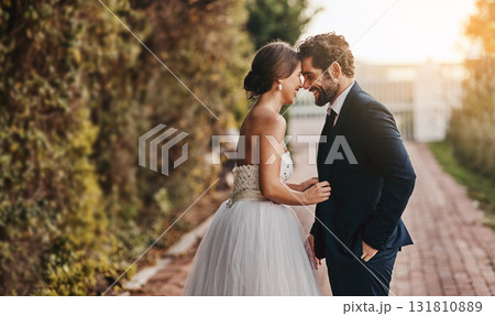 Love, wedding and couple with smile in garden for marriage, ceremony celebration and commitment. Affection, trust and bride and groom hug, embrace and happy for romance, bonding and loving in park Love, wedding and couple with smile in garden for marriage, ceremony celebration and commitment. Affection, trust and bride and groom hug, embrace and happy for romance, bonding and loving in park 131810889