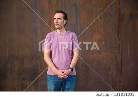Casual Man Standing Outdoors Near Stairs and Greenery for Everyday Fashion and Lifestyle Photo Casual Man Standing Outdoors Near Stairs and Greenery for Everyday Fashion and Lifestyle Photo 131811039