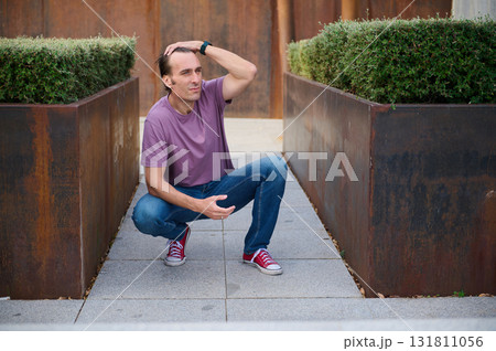 Casual Man Standing Outdoors  Near Stairs and Greenery for Everyday Fashion and Lifestyle Photo 131811056