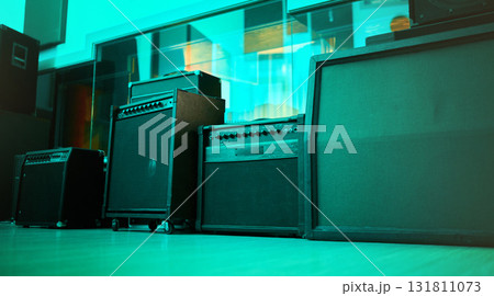Vintage, retro and old speakers or music equipment in studio or room with neon blue light for entertainment. Stereo, record and audio tools or loudspeaker with volume and sound as 90s technology 131811073