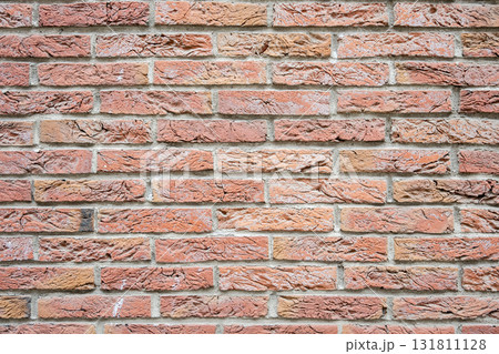 Brown structural stone wall of the ancient building consists of bricks. Nature structural background. 131811128