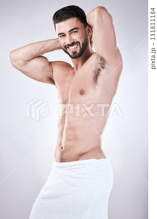 Muscular man, portrait smile and towel flexing for clean hygiene, wash or skincare isolated on gray studio background. Happy attractive male model smiling for fit body, cosmetics or fresh grooming Muscular man, portrait smile and towel flexing for clean hygiene, wash or skincare isolated on gray studio background. Happy attractive male model smiling for fit body, cosmetics or fresh grooming 131811184