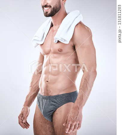 Sexy, underwear and man with muscle as beauty, skincare or self care isolated in studio gray background. Model, handsome and perfect athletic body of masculine male is confident with a towel 131811203