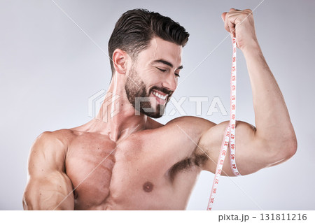 Fitness, body and strong man with tape measure for biceps for exercise goals on studio background. Happy bodybuilder measuring arm for training, workout or muscle growth progress, results or target 131811216