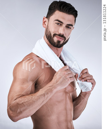 Portrait, fitness or man with towel after shower, cleaning or bathing for healthy body hygiene or wellness. Topless, goals or model with six pack, abs or biceps muscles isolated on studio background 131811224