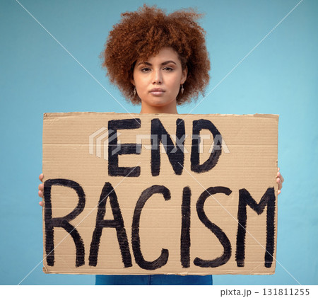Poster, political and portrait of a woman in a studio for a protest for racism, equality and human rights, Freedom, social justice and female from Mexico with a sign for a rally by a blue background. Poster, political and portrait of a woman in a studio for a protest for racism, equality and human rights, Freedom, social justice and female from Mexico with a sign for a rally by a blue background. 131811255